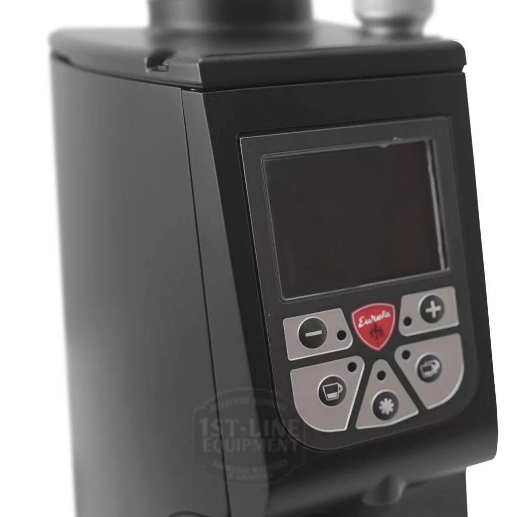 Close-up of the discontinued Eureka Atom Specialty 65 Espresso Coffee Grinder w/ Short Bean Hopper, showing its digital display, control buttons, and visible Eureka logo below the screen. © 2025 1st-line.com