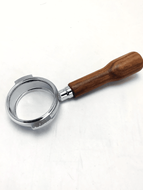 A Bezzera 5965635R E61 Wood Handle 58mm Bottomless Portafilter, empty and viewed from above at a slight angle, rests on a white surface. © 2025 1st-line.com