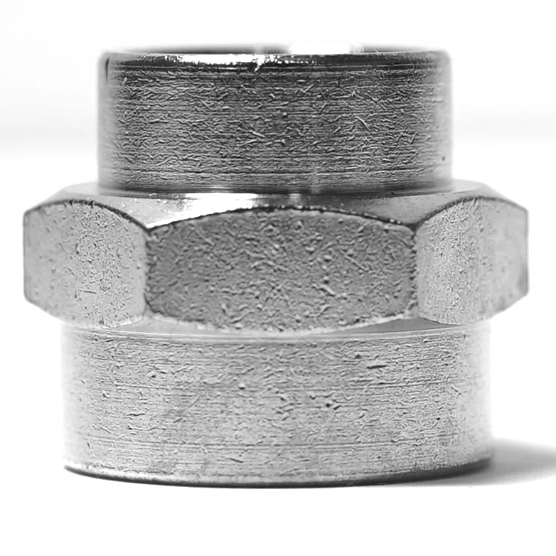 Close-up photo of the Ascaso V.2200 1/2 F X 3/4 F Fitting, highlighting its metallic hexagonal nut with detailed grooves and textured surface, isolated on a white background. © 2025 1st-line.com