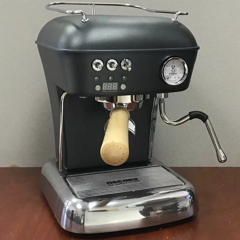 The SOLD Ascaso Dream UP V3 Anthracite Gray PID Espresso Machine (returned & refurbished), featuring a black body, chrome accents, pressure gauge, digital display, wooden portafilter handle, and steam wand, sits on a wooden surface. © 2025 1st-line.com