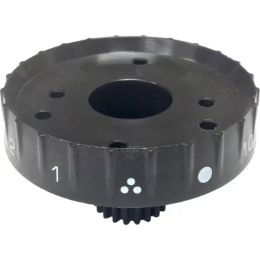 The Lelit 3700044 Grinding Adjustment Wheel is black and circular with numbered markings, a central hole, several smaller holes on its flat surface, edge grip notches, and white indicator symbols. © 2025 1st-line.com
