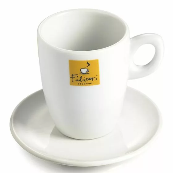 The DISCONTINUED Filicori Zecchini Coffee Mug & Saucer is a white ceramic set featuring a handle and matching saucer. The mug displays a yellow square Filicori Zecchini logo with black text and a steaming cup illustration. © 2025 1st-line.com