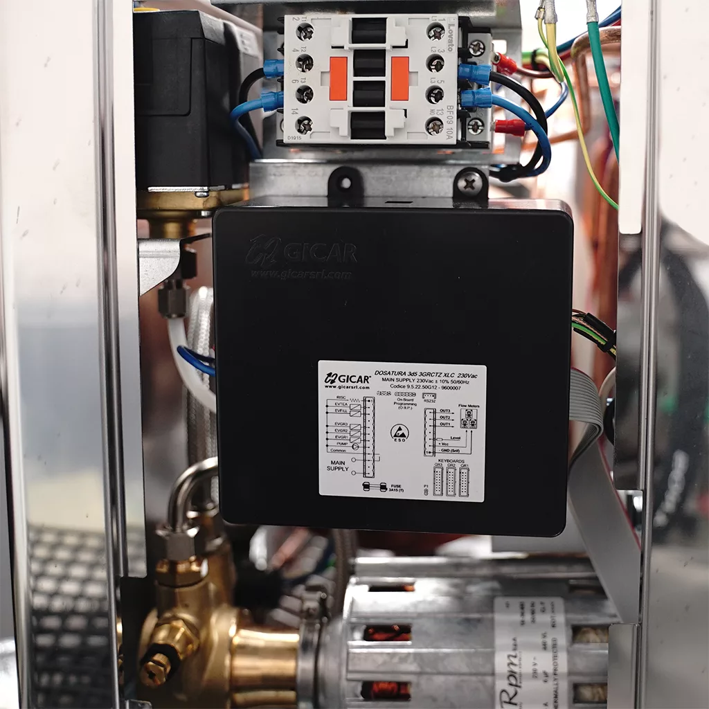 Close-up of an electrical control box inside the DISCONTINUED Lelit PL2SVH2 Giulietta Espresso Machine for Commercial Use - 2 Group, 220v. The GICAR label and diagram are visible, with metal parts, wires, and the motor at the bottom. © 2025 1st-line.com