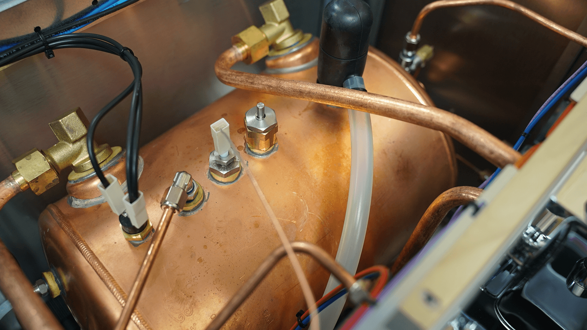 Close-up of the copper boiler, pipes, brass fittings, and electrical components inside the DISCONTINUED Lelit PL2SVH2 Giulietta 2 Group Commercial Espresso Machine (220V), highlighting its detailed internal mechanisms. © 2025 1st-line.com