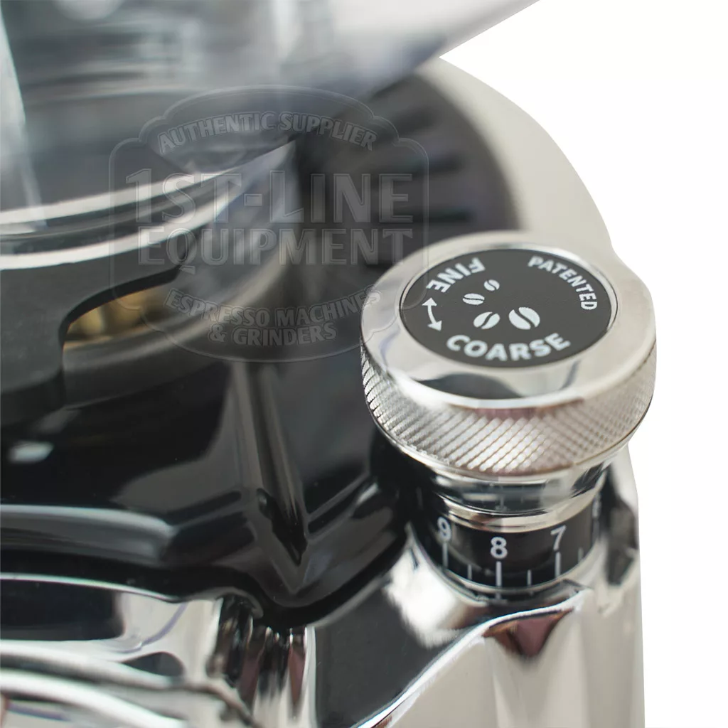A close-up of the DISCONTINUED Eureka Zenith 65 E Espresso Coffee Grinders adjustment knob shows grind settings from 1 to 9, a metallic finish, engraved labels, and precision steel burrs beneath the tall bean hopper. © 2025 1st-line.com