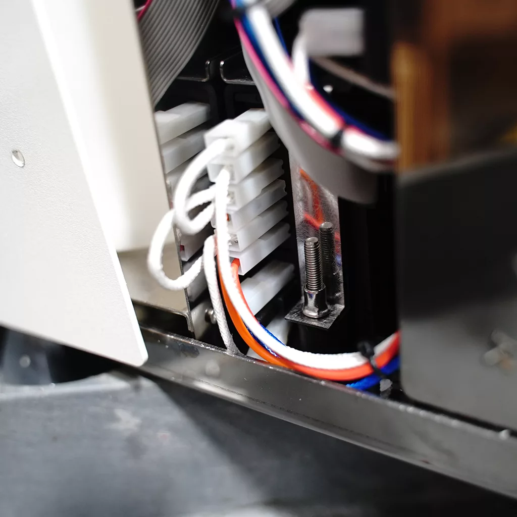 Close-up of the ACS Minima Dual Boiler Espresso Machine interior, displaying colored wires, a white terminal block, metal parts, and connectors. © 2025 1st-line.com