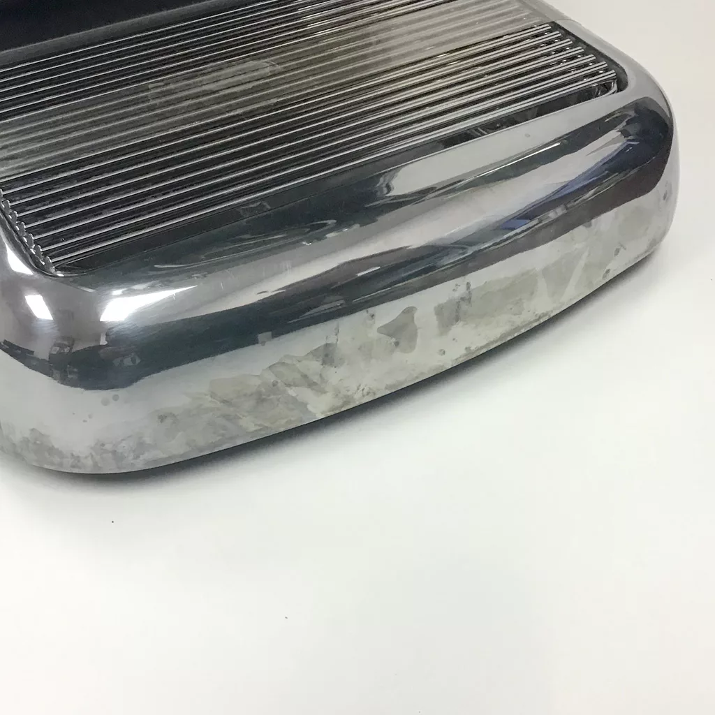 A close-up of a refurbished SOLD Ascaso Dream Anthracite Gray Espresso Machine (boiler version) with a ribbed top, showing some smudges and discoloration, placed on a plain white background. © 2025 1st-line.com