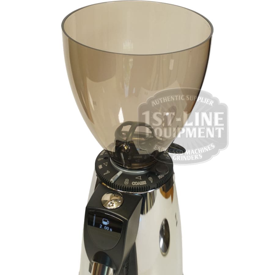 A close-up of the Elektra MXD Maxi Digital Espresso Coffee Grinder shows its clear bean hopper, digital display, and grind size adjustment dial; a 1st-Line Equipment logo watermark appears in the image. © 2025 1st-line.com