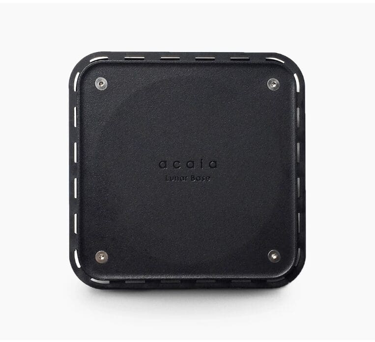 A black, square DISCONTINUED Acaia Lunar Base for the Lunar Espresso Scale with rounded corners and four screws, viewed from above on a white background. The words acaia Lunar Base are printed in the center. © 2025 1st-line.com
