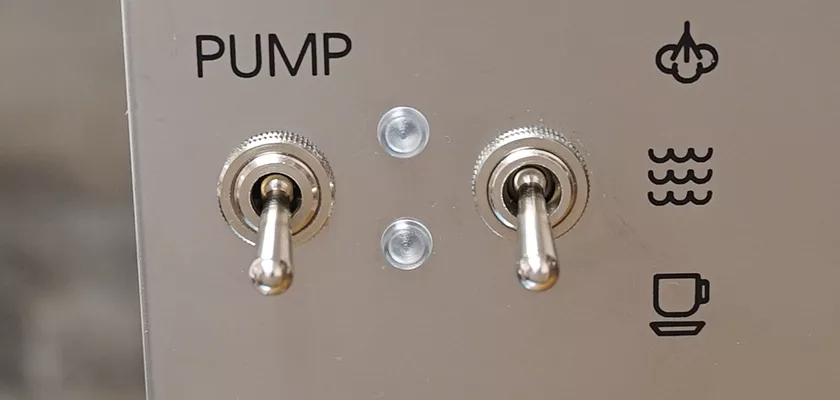 Close-up of two metal toggle switches labeled PUMP on the discontinued Lelit Glenda PL41PLUST PID Espresso & Cappuccino Machine panel, with steam, water, and coffee cup icons to the right. © 2025 1st-line.com