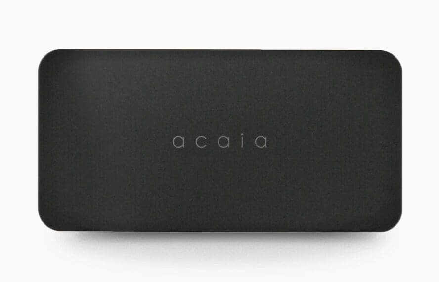 The DISCONTINUED Acaia Lunar Portafilter Weighing Plate is a rectangular black accessory with rounded corners and acaia in lowercase at the center, designed for precise espresso measurements with the Acaia Lunar scale. © 2025 1st-line.com
