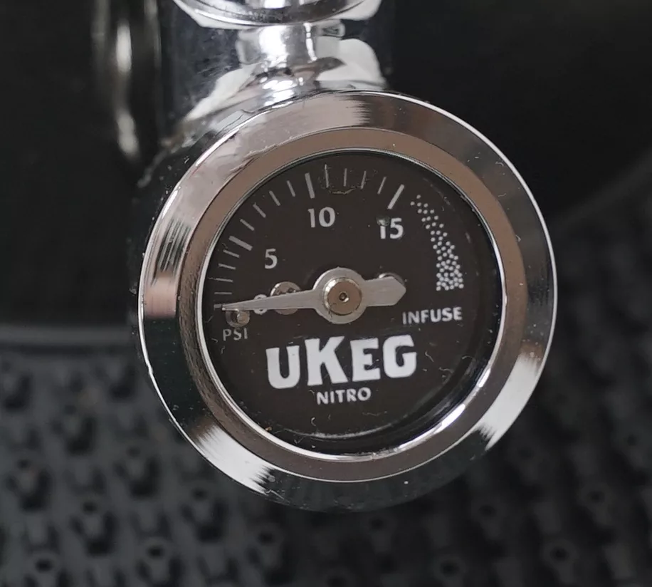 Close-up of a chrome pressure gauge on the DISCONTINUED GrowlerWerks uKeg Nitro Cold Brew Coffee Maker with N2O, showing 0–15 PSI; dial points to 5 PSI with INFUSE printed on the face. © 2025 1st-line.com