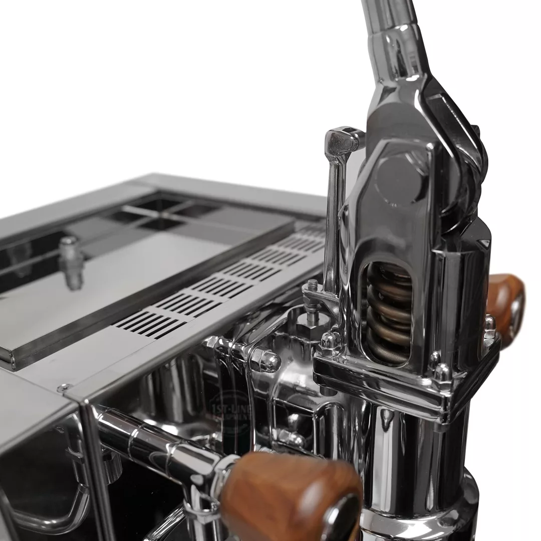 Close-up of the DISCONTINUED Izzo Valexia Leva Espresso Machine, featuring a polished metallic finish, wooden handles, and a visible spring mechanism that highlights its modern design. © 2025 1st-line.com
