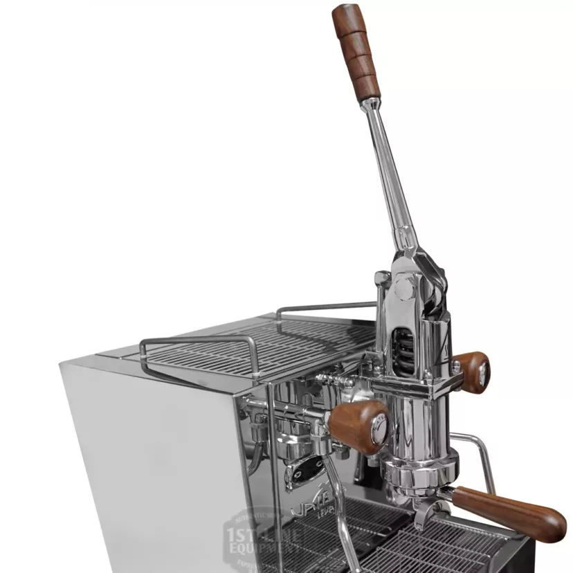 A close-up of the discontinued Izzo Valexia Duetto II Dual Boiler Espresso Machine, featuring a polished chrome finish, wooden handles, a manual lever, drip tray, and cup platform—showcasing its blend of modern and retro industrial design. © 2025 1st-line.com