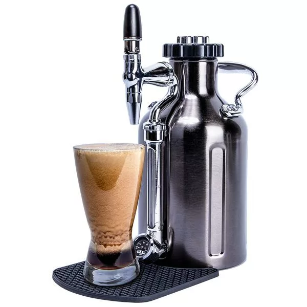 The discontinued GrowlerWerks uKeg Nitro Cold Brew Coffee Maker with N2O sits beside a glass of foamy coffee on a black mat against a white background; also ideal for draft beer. © 2025 1st-line.com
