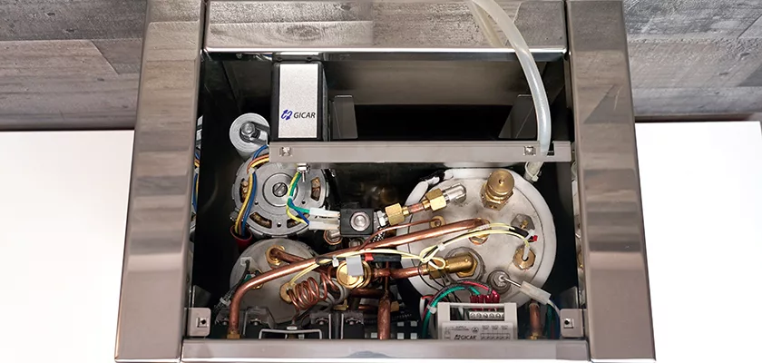 Top-down view of the internal components of the DISCONTINUED Izzo Valexia Duetto II Dual Boiler Espresso Machine, displaying wiring, copper pipes, boilers, and metal parts inside a stainless steel frame. © 2025 1st-line.com