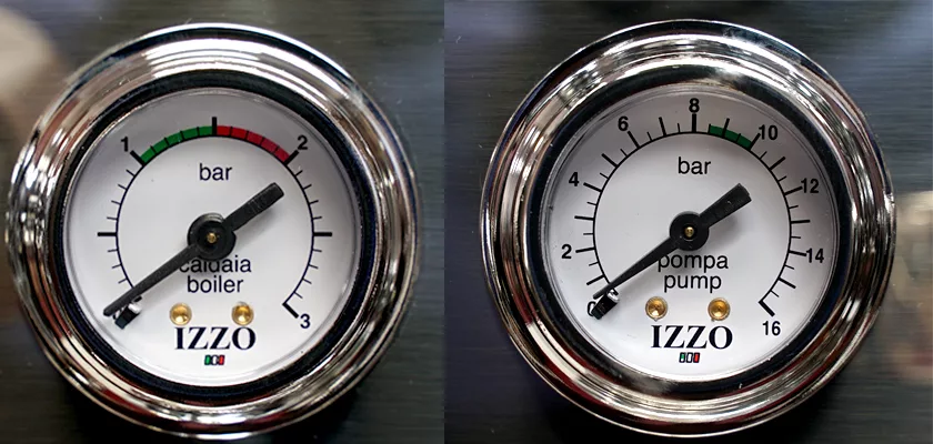 Two round analog IZZO-branded gauges on the DISCONTINUED Izzo Valexia Duetto II Dual Boiler Espresso Machine show boiler pressure at 1.2 bar (left) and pump pressure just over 9 bar (right), both measured in bars. © 2025 1st-line.com