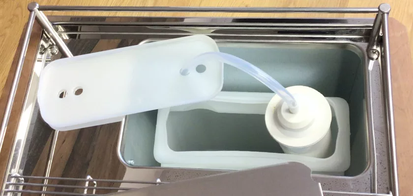 A close-up of an ice cream maker’s freezing chamber showcases its plastic lid, tube, and mixing paddle in a stainless steel container, reflecting the precision engineering of the Elektra Verve Dual Boiler Espresso Machine. © 2025 1st-line.com