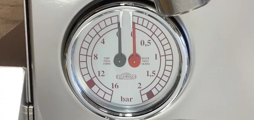 A close-up of the Elektra Verve Dual Boiler Espresso Machines pressure gauge, labeled Elektra, displays a reading just above 0 bar. The gauge measures pressure in bars with dual scales: 0–2 and 0–16. © 2025 1st-line.com