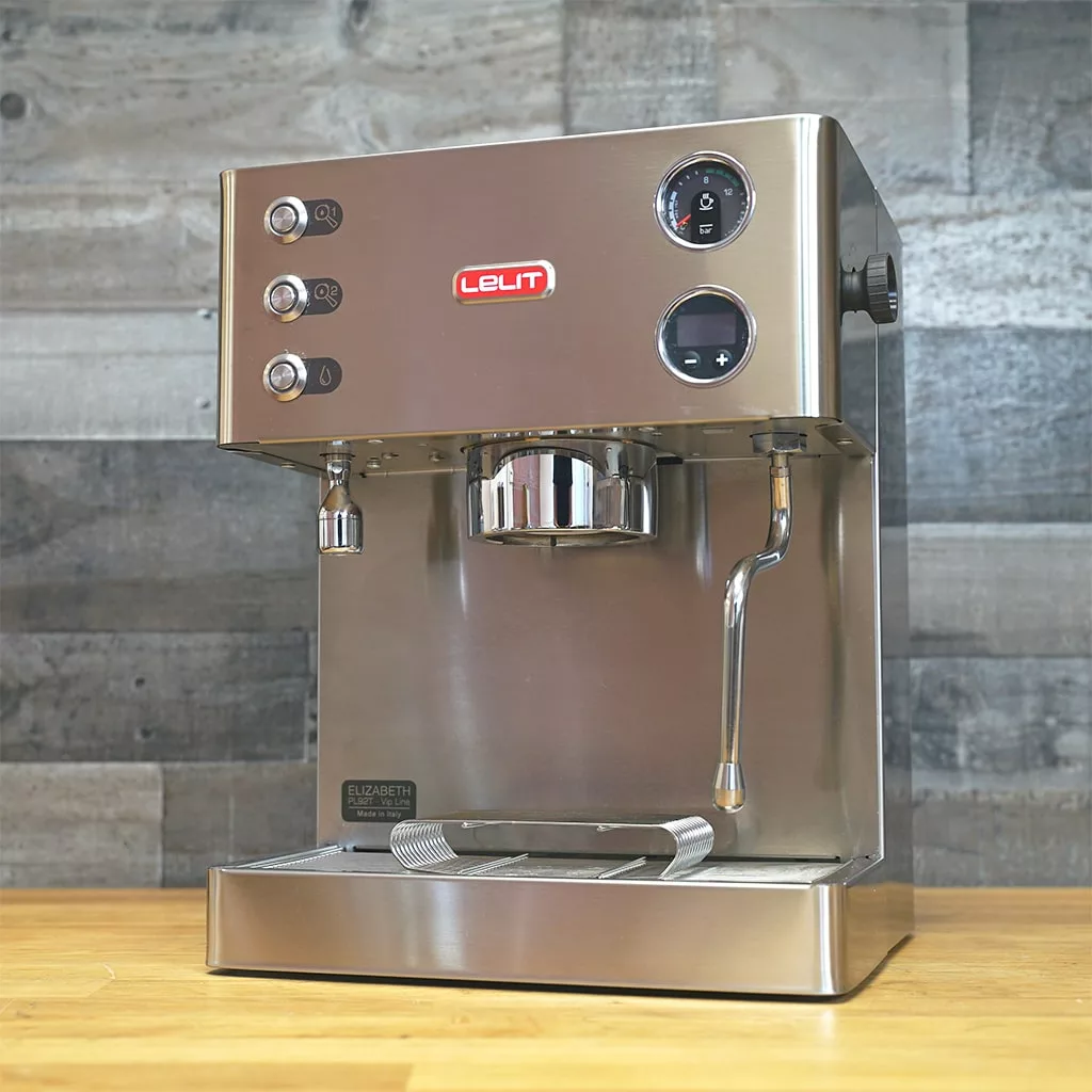 A (SOLD) SIDEWALK SALE - Lelit PL92T Elizabeth PID Version 3 Dual Boiler Espresso Machine (RETURNED & REFURBISHED) E211 with round buttons, a pressure gauge, steam wand, and red logo sits on a wooden counter by gray tiles. © 2025 1st-line.com