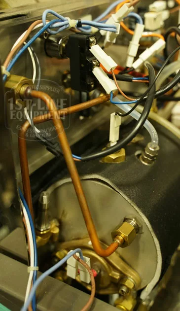 Close-up of the Elektra Verve Dual Boiler Espresso Machine’s internal components, showing copper pipes, electrical wiring, connectors, and metal fittings within the dual boiler assembly. © 2025 1st-line.com