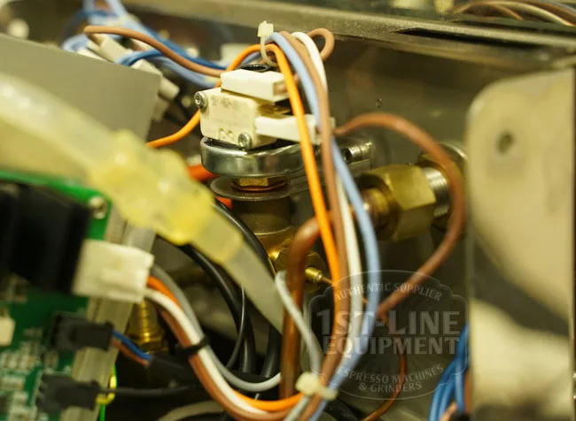 Close-up of the Elektra Verve Dual Boiler Espresso Machines internal wiring and components, highlighting colored wires connected to circuit boards and metal parts. © 2025 1st-line.com