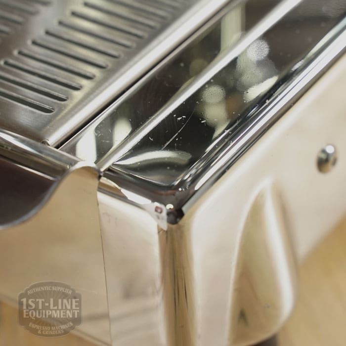 Close-up of a Like NEW- La Nuova Era Cuadra Espresso Machine - V3 Chrome Color (C105), showing shiny chrome with visible scratches and reflections. The faint 1st-Line Equipment logo appears in the bottom left corner. © 2025 1st-line.com