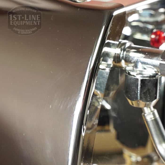 Close-up of a shiny chrome part on the Like NEW- La Nuova Era Cuadra Espresso Machine - V3 Chrome Color (C105), with reflections and the engraved “1st-Line Equipment” logo, highlighting this model’s quality craftsmanship. © 2025 1st-line.com