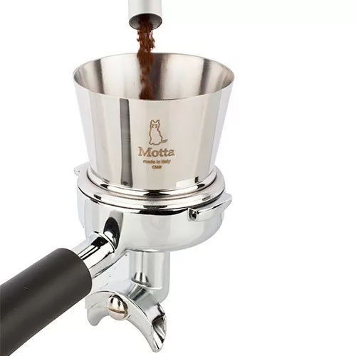Ground coffee is dispensed into the Motta Coffee Grinder Funnel - 60mm height, which sits on a portafilter for espresso preparation. © 2025 1st-line.com