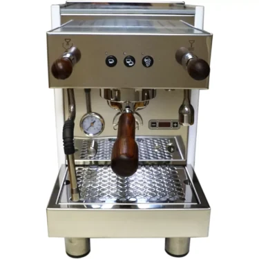 The Bezzera Crema DE HX Espresso Machine features a stainless steel body, wooden handles, a left-side steam wand, front control buttons and gauge, and a metal drip tray at the bottom. © 2025 1st-line.com