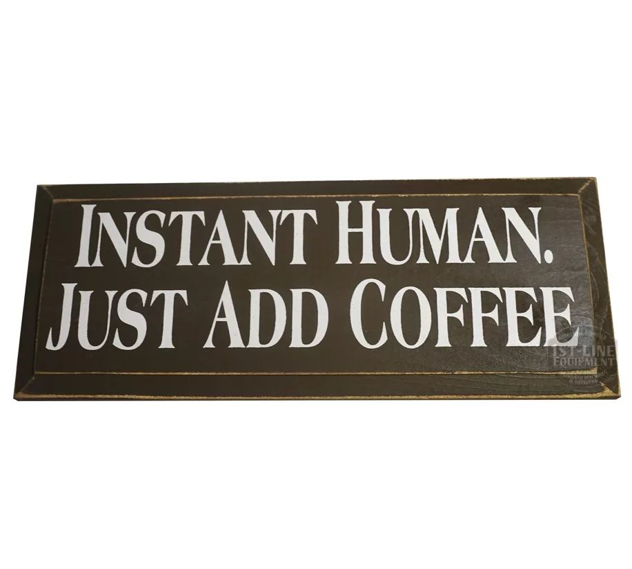 The Instant Human Just Add Coffee Sign by 1st-line Equipment is a brown rectangular sign with white text—a fun décor piece for coffee enthusiasts. © 2025 1st-line.com
