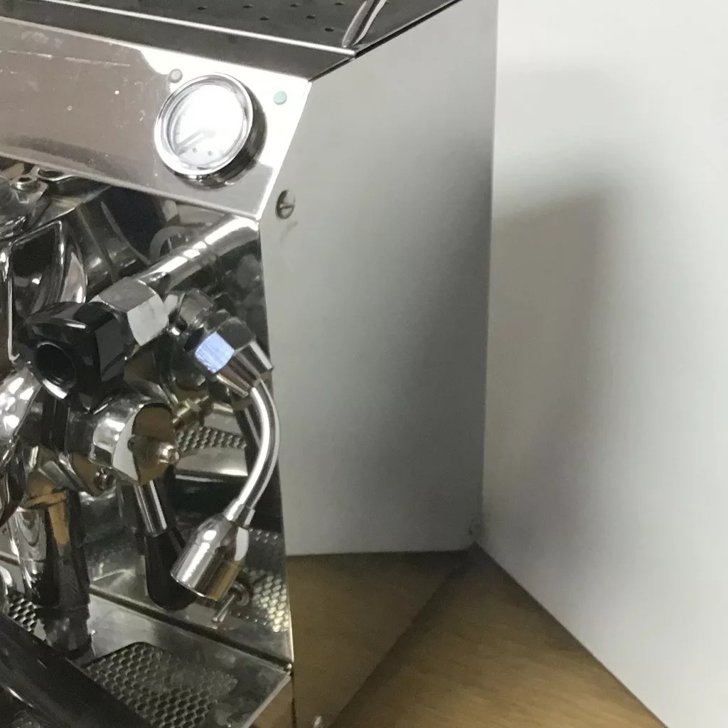 A close-up of the SOLD SIDEWALK SALE VBM Domobar Junior HX Espresso Machine highlights its steam wand, pressure gauge, and knobs on a wooden countertop—an elegant white-wall backdrop for your next great find. © 2025 1st-line.com