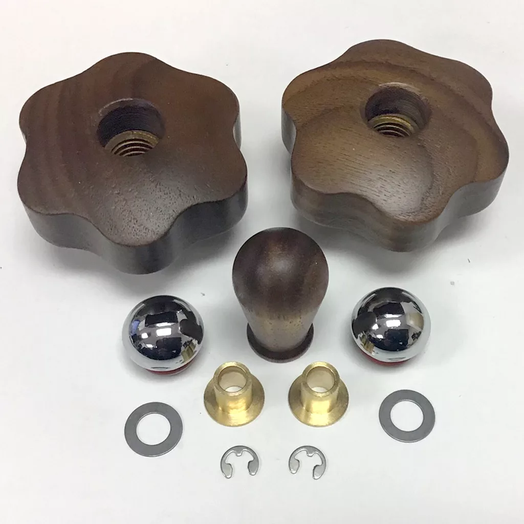 The Lelit PLA2200 Wood Steam/Hot Water Knob Kit for PL62 Mara models is arranged neatly on a white background, showing two dark wood flower knobs, a small wood knob, two metal spheres, brass cones, washers, and C-clips. © 2025 1st-line.com