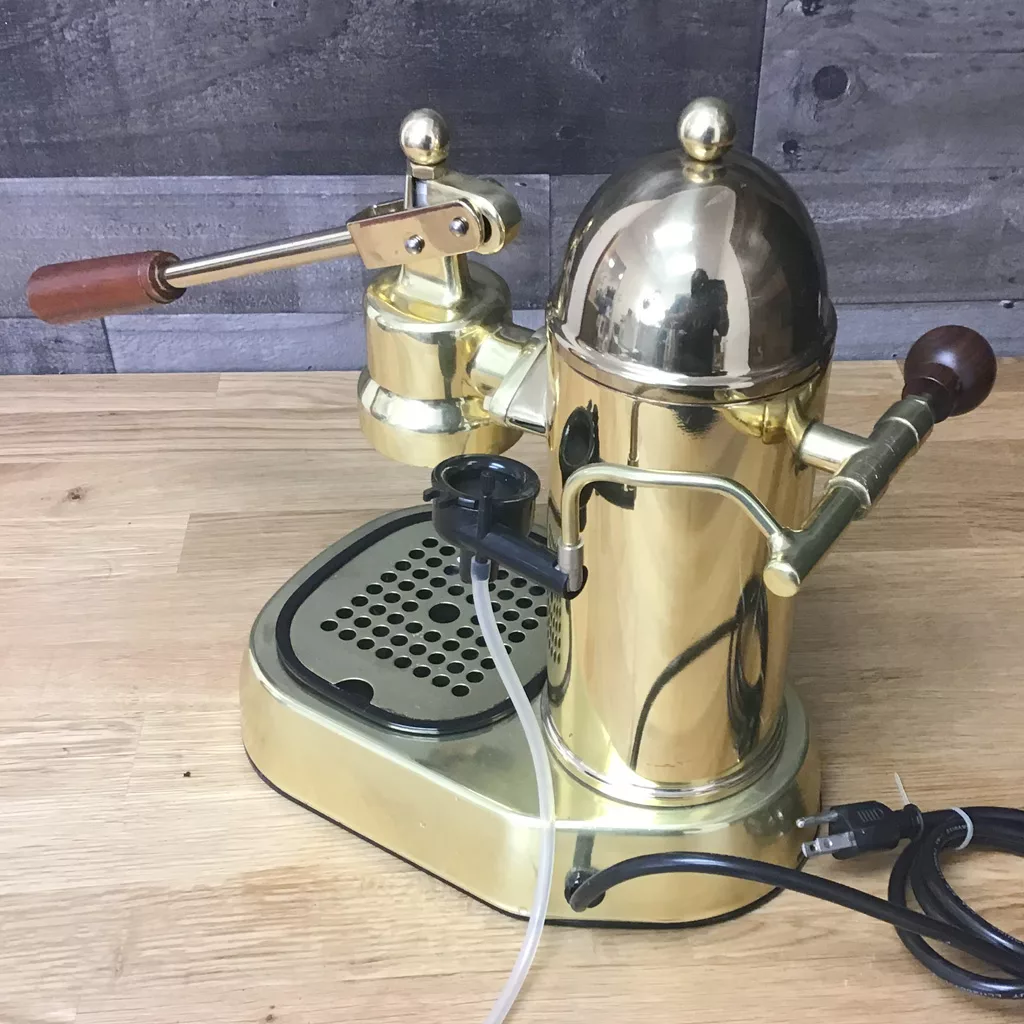 A SOLD IN STORE PICKUP ONLY USED La Pavoni 16-Cup Professional Brass Lever Espresso Machine with wooden handles sits on a wooden countertop, featuring a classic lever, drip tray, and attached power cord. © 2025 1st-line.com