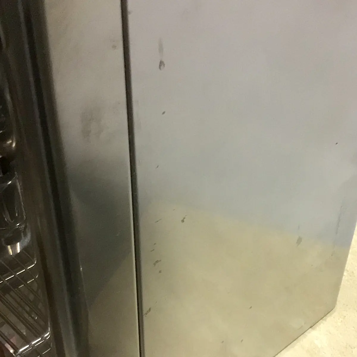 A close-up of the stainless steel side of a SOLD SIDEWALK SALE - Lelit Mara X PL62X HX Espresso Machine (used) (E213), showing small smudges and fingerprints like those found on demo units at busy sales.
