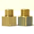 Two brass 1st-line Reducer 1/2F X 3/8M fittings with male threads stand upright on a white surface. They feature a shiny finish and visible machining marks against a pale background. © 2025 1st-line.com