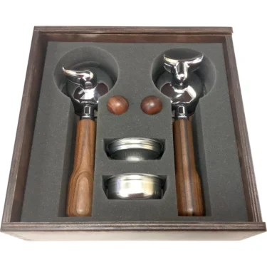 The Bezzera 5963152.01 Unica Wood Portafilter & Knob Kit includes two wood-handled portafilters, two metal filter baskets, and two wooden spheres, all neatly arranged in foam cutouts. © 2025 1st-line.com