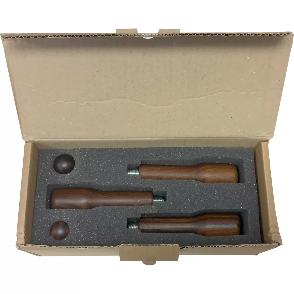 The Bezzera 5963156.01 Strega Wood Filter Handle & Knob Kit includes three wooden filter handles and two round wooden knobs in a foam-padded box with individual cutouts, ideal as replacement or accessory parts for Bezzera Strega. © 2025 1st-line.com