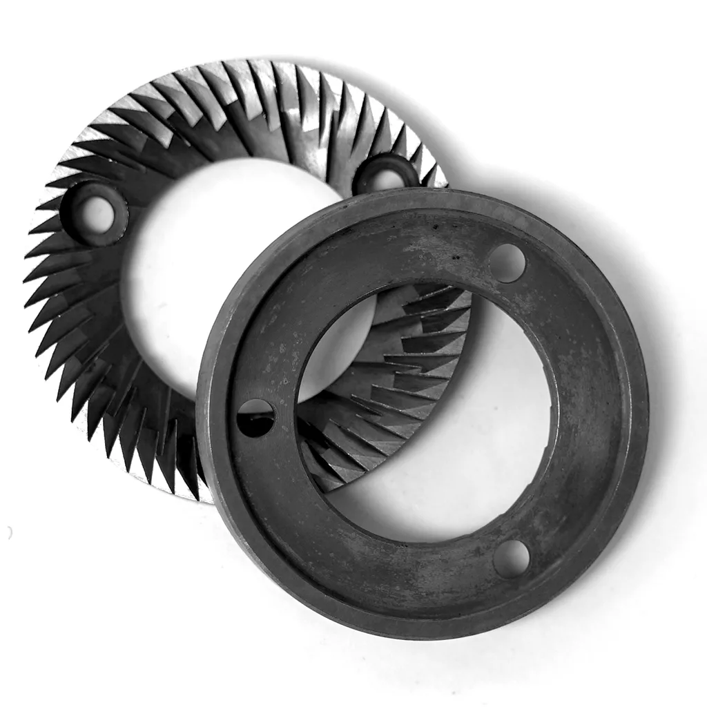 Two overlapping circular 58mm metal burrs with sharp, angled teeth and three holes, used as grinding components in the Fiorenzato Flat Grinders Machine Plane. The black-and-white image highlights their design. © 2025 1st-line.com