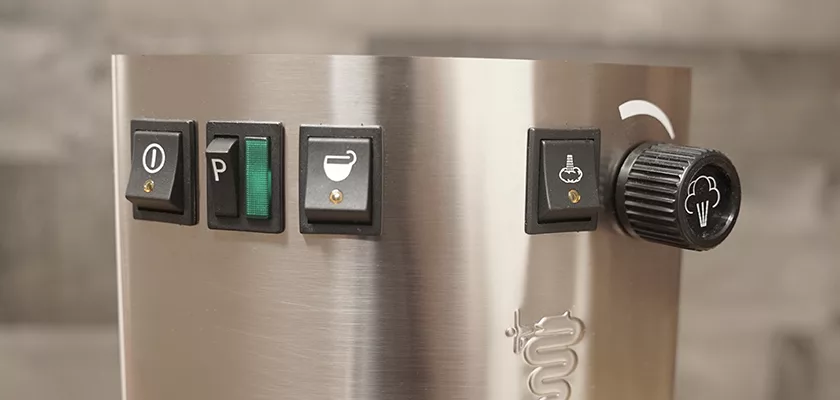 Close-up of the Bezzera New Hobby Espresso Machine control panel, featuring four black buttons with icons and a black steam dial on the right—ideal for espresso enthusiasts starting out. © 2025 1st-line.com