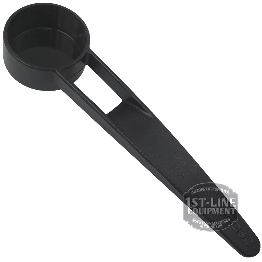 The V..520 PLASTIC SPOON is a black plastic coffee scoop with a flat handle, featuring an open rectangular section near the scoop and displaying a subtle V520 and 1st-Line Equipment logo watermark on the handle. © 2025 1st-line.com