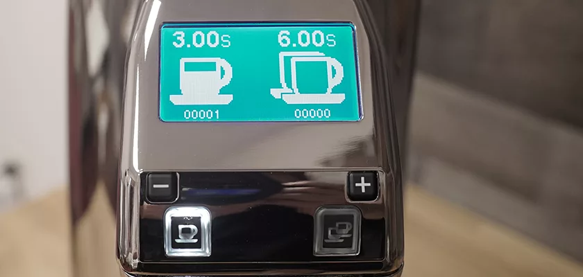 Close-up of the DISCONTINUED Eureka Olympus 75E High Speed Espresso Coffee Grinder w/ Titanium Burrs display, showing two cup timer settings (3.0 & 6.0 sec), cup symbol buttons, and plus/minus controls for precision espresso grinding. © 2025 1st-line.com