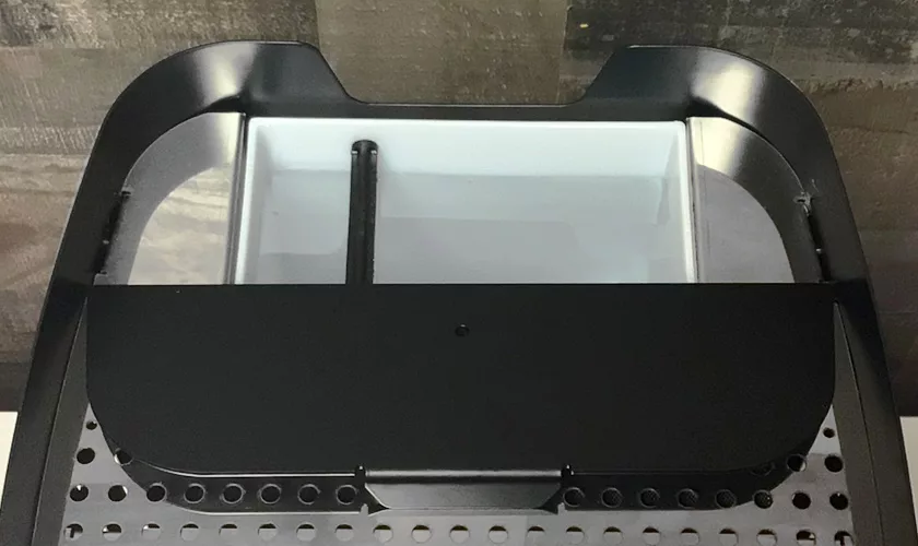 Close-up of the black and silver drip tray and removable water tank from the VBM Junior Digital HX Espresso Machine w/ Flow Control, displayed on a dark surface. © 2025 1st-line.com