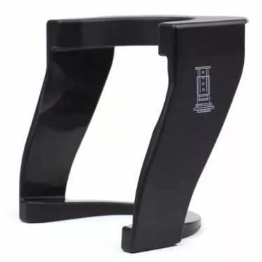 Lightweight black plastic guitar stand with a curved design and open sides, featuring an amplifier illustration—perfect for displaying guitars, BARATZAgear Baratza Sette Aeropress Holder, or other gear. © 2025 1st-line.com