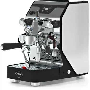 The VBM Junior Digital HX Espresso Machine w/ Flow Control showcases a stylish black and white design, chrome accents, dual handles, flow control, and a pressure gauge on a reflective drip tray featuring the VBM logo. © 2025 1st-line.com
