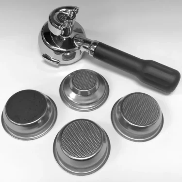 The Lelit PLA582S 58 mm Coffee Slide Spout Black Handle Portafilter Kit is shown on a white surface, including a black handle portafilter and four espresso filter baskets, each with a distinct mesh pattern. © 2025 1st-line.com