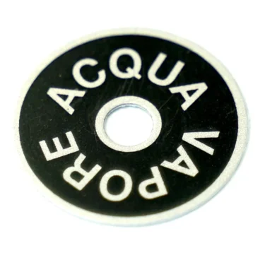 The ECM B5522057 Disc for Front of Knob is a round black and silver washer labeled ACQUA VAPORE in a circular pattern around the center hole, designed as an ECM replacement part. © 2025 1st-line.com