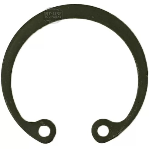 The F.1270 SEEGER is a black metal snap ring with two holes at the open ends, forming a near-complete circle, designed to secure parts on shafts or in housings. © 2025 1st-line.com