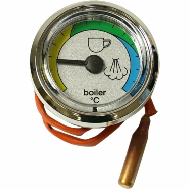 A close-up of the DISCONTINUED Lelit MC258 Pressure Gauge shows colored sections—green (coffee cup icon), blue (steam icon), and yellow for low temperatures—with an orange wire attached at the bottom. © 2025 1st-line.com