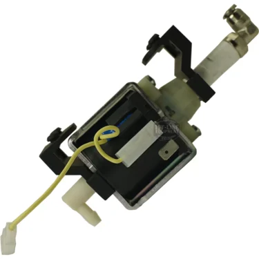 A close-up of the Lelit 4000040 Silent Vibration Pump featuring a metal frame, plastic fittings, and a yellow wire attached, angled against a white background. © 2025 1st-line.com